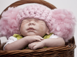 Baby pink fluffy hat created using yarn