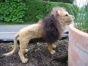 Lion in the garden created using needle felt